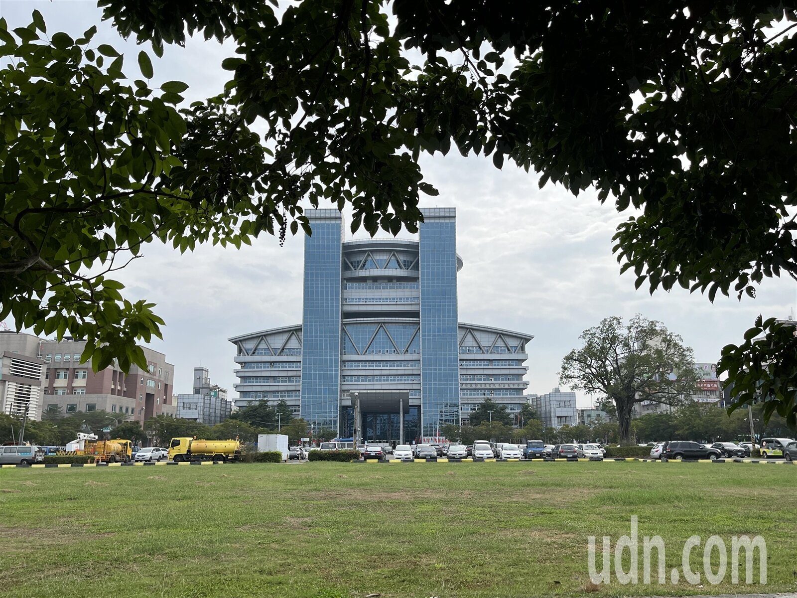嘉義市府北棟大樓預定地現為停車場及綠地,正前方為南棟大樓。記者李宗祐/攝影