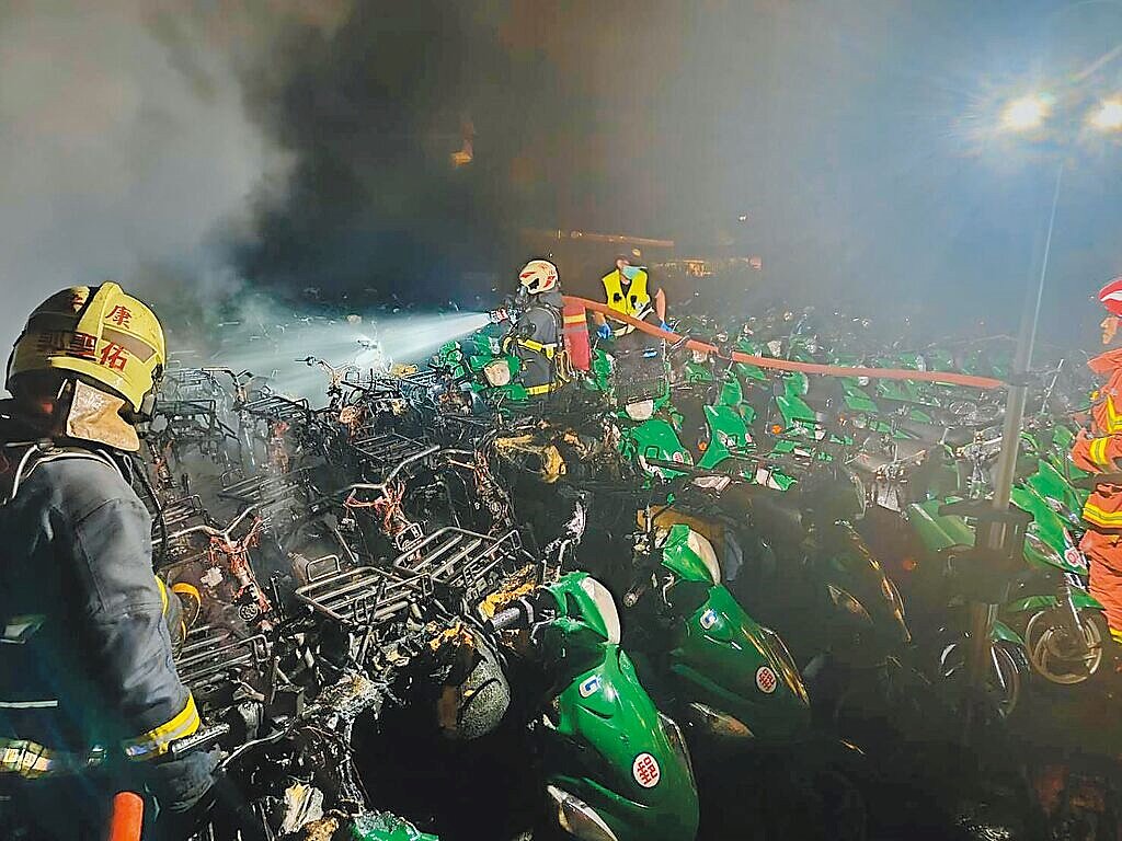 中華郵政公司新店青潭戶外停車場20日深夜發生火警，101輛報廢電動機車燒毀，僅剩骨架。（新北市消防局提供／王揚傑新北傳真）