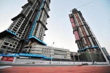 大陸房價居高不下，銀行業者擔心房價下跌風險，近期開始緊縮房貸業務。圖為福建福州市區興建中的房子。
（中新社）