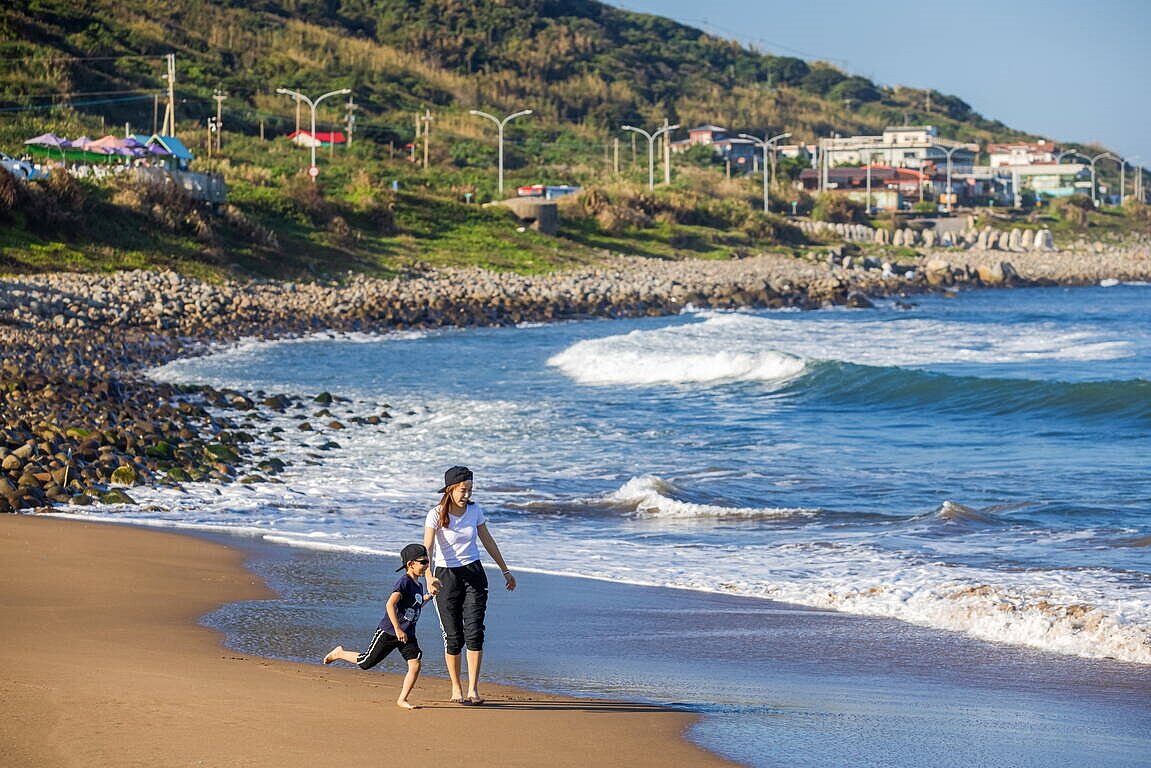 金山中角灣是北海岸名聞遐邇的衝浪天堂,淺灘區沙子細膩少有石頭。圖/新北市政府提供