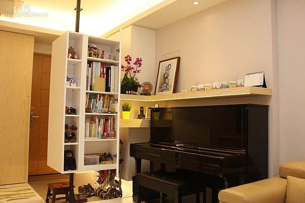 4.鋼琴旁的層板櫃包括方向、高度全針對鋼琴尺寸重新設計,上方擺滿著全家福照片、盆栽、以及星巴克城市杯…等物品。