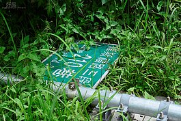 羅斯福路與辛亥路交叉口旁的假公園，竟然出現倒掉的路牌，且公共物品倒在公園中卻無人管理，令人啼笑皆非。（好房News記者 陳韋帆／攝影）